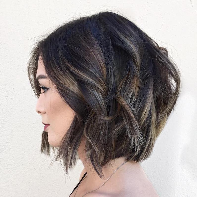 Woman with soft blonde layered bob with subtle balayage highlights
